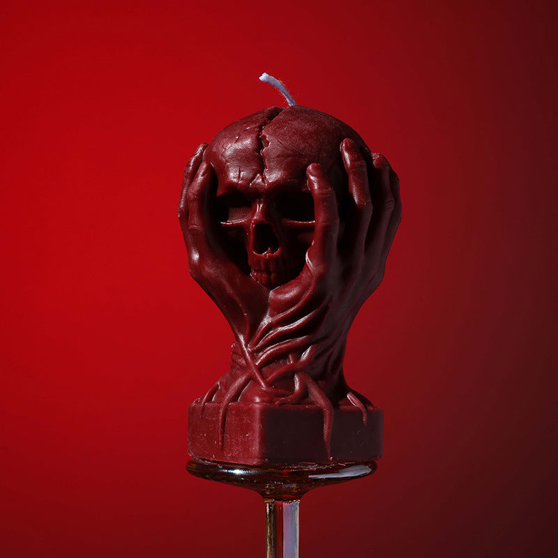Holding a skull low temperature candle