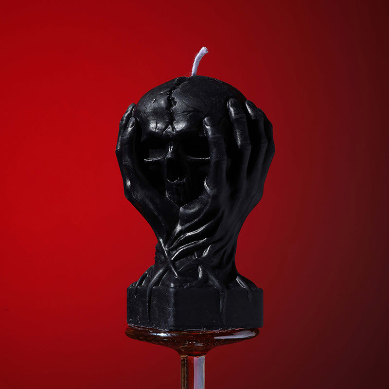 Holding a skull low temperature candle